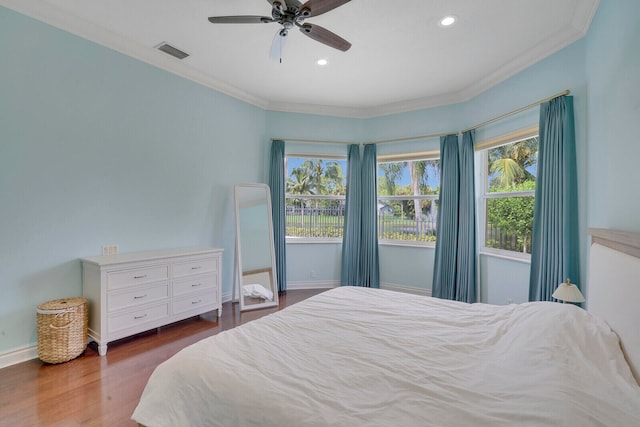 bedroom with ceiling fan, dark hardwood / wood-style flooring, and crown molding