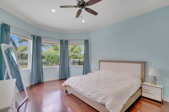 bedroom featuring hardwood / wood-style flooring, ceiling fan, and ornamental molding