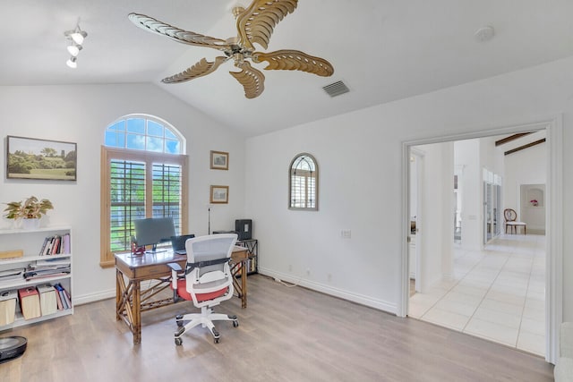 home office with ceiling fan, lofted ceiling, and light hardwood / wood-style flooring