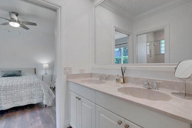 bathroom featuring walk in shower, ornamental molding, vanity, ceiling fan, and hardwood / wood-style flooring