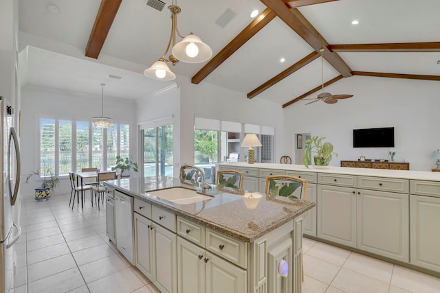 kitchen featuring stainless steel appliances, sink, pendant lighting, vaulted ceiling with beams, and an island with sink