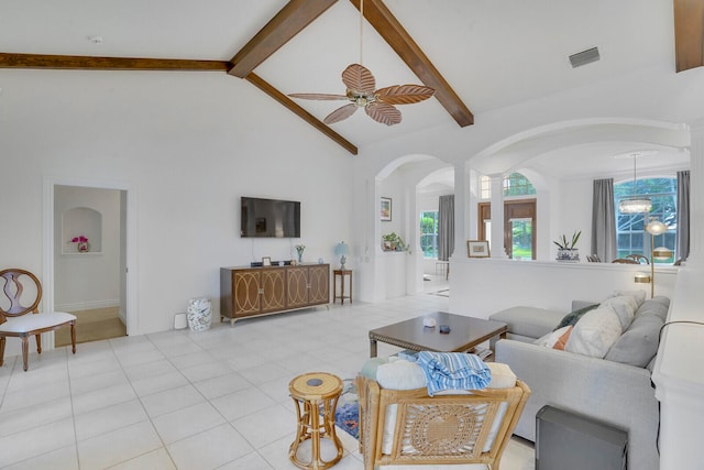 living room featuring beam ceiling, light tile patterned flooring, ceiling fan with notable chandelier, and high vaulted ceiling