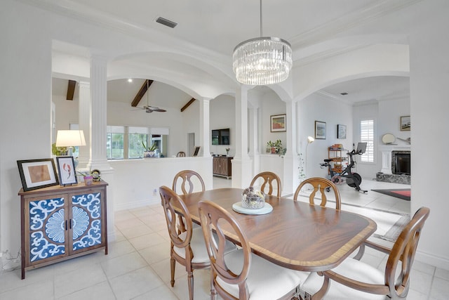 dining area with beamed ceiling, light tile patterned floors, ceiling fan with notable chandelier, and ornamental molding