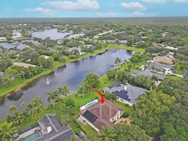 birds eye view of property with a water view