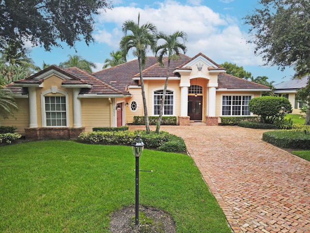 mediterranean / spanish home with a front yard