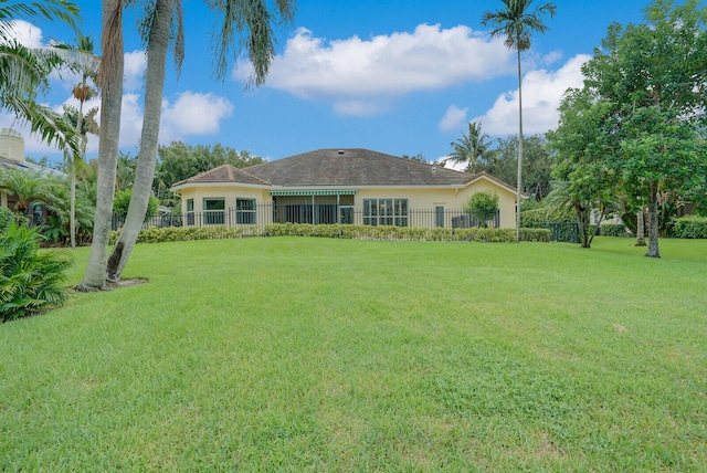 rear view of property with a yard