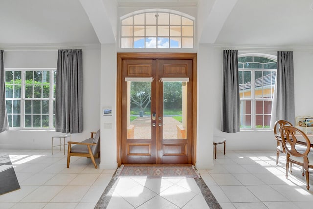 entryway with crown molding and plenty of natural light