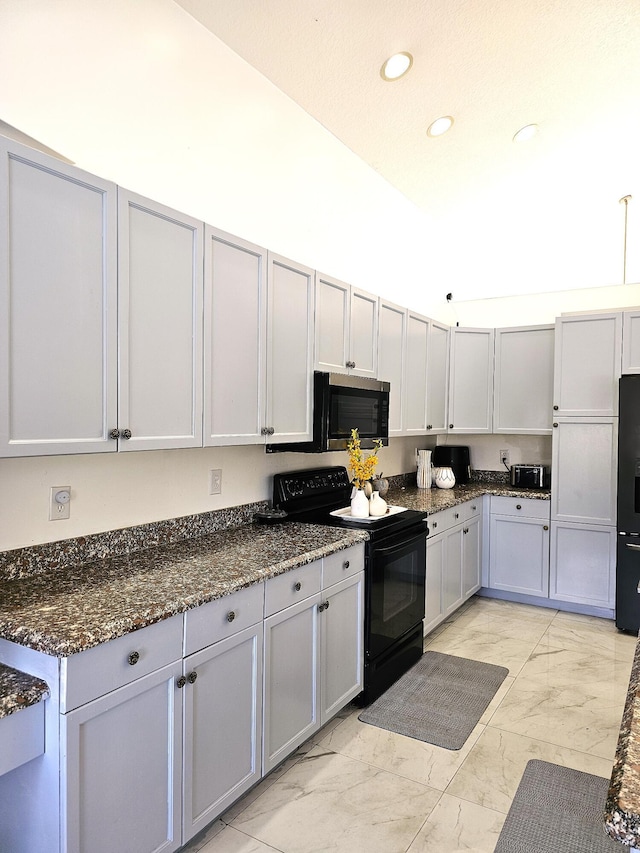 kitchen with black appliances, marble finish floor, dark stone countertops, and recessed lighting