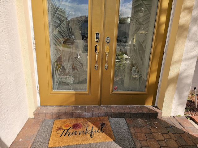 property entrance with stucco siding