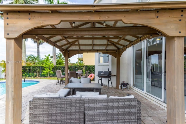 view of patio with a fenced in pool, an outdoor hangout area, a grill, fence, and a gazebo