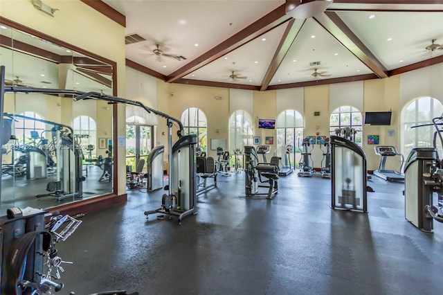 workout area with recessed lighting, a healthy amount of sunlight, visible vents, and a high ceiling