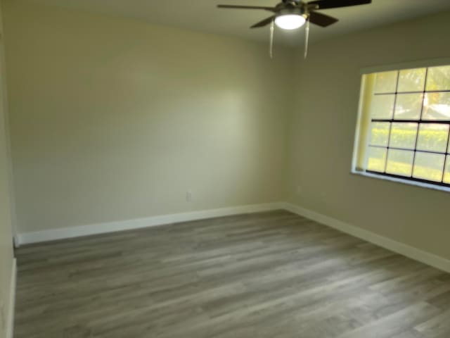 empty room with light hardwood / wood-style flooring and ceiling fan