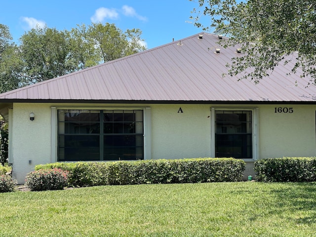 view of property exterior featuring a lawn