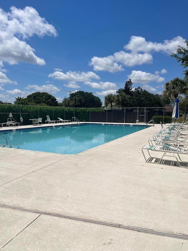 view of swimming pool with a patio