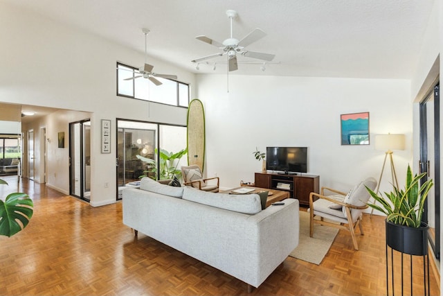 living room with ceiling fan, parquet floors, and high vaulted ceiling