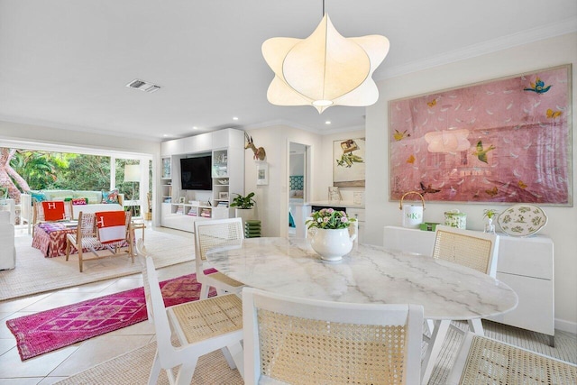 tiled dining area featuring crown molding