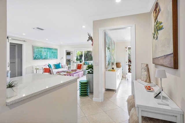 interior space featuring crown molding and light tile patterned floors