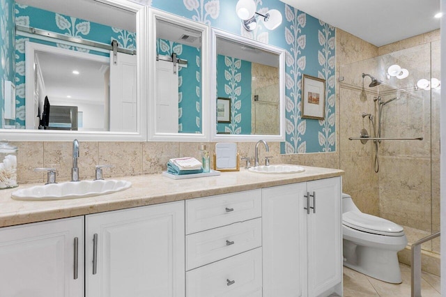 bathroom featuring vanity, tile patterned floors, toilet, and tiled shower