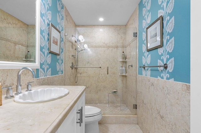 bathroom featuring vanity, toilet, tile patterned flooring, and a shower with door