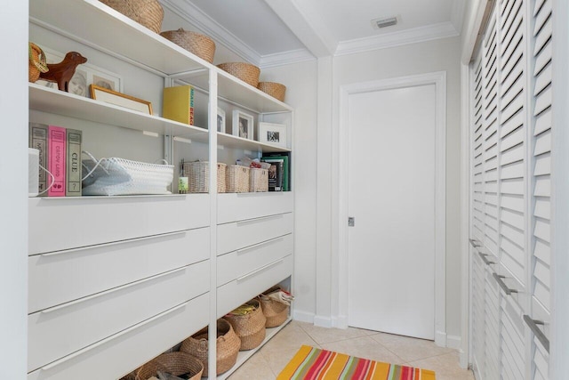 interior space with light tile patterned floors and crown molding