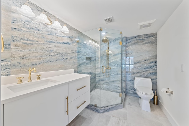 bathroom featuring tile walls, vanity, an enclosed shower, and toilet