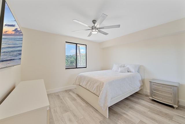 bedroom with ceiling fan and light wood-type flooring