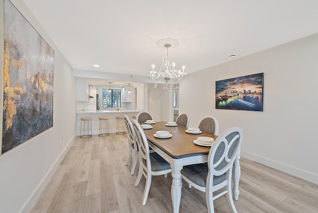 dining area featuring a chandelier and light wood-type flooring