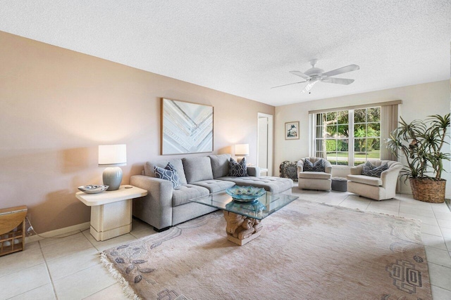 tiled living room featuring ceiling fan and a textured ceiling