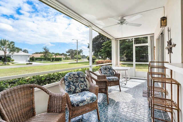 sunroom / solarium featuring ceiling fan