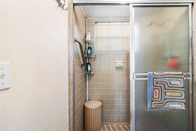 bathroom featuring a shower with door