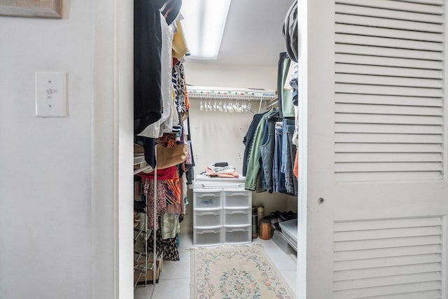 spacious closet with light tile patterned floors