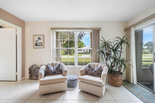 sitting room featuring light tile patterned floors and a textured ceiling