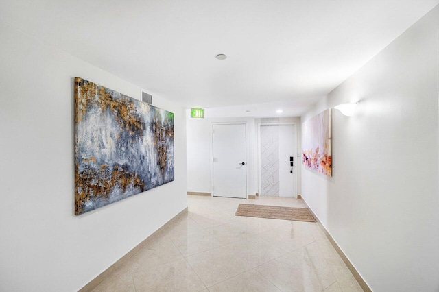 hallway featuring light tile patterned floors