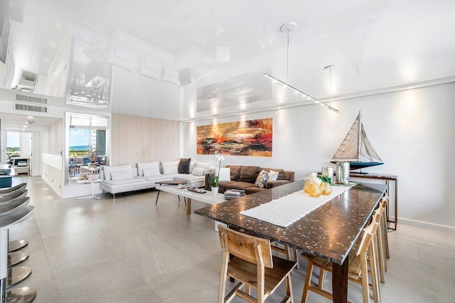 dining area featuring a towering ceiling