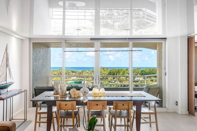 tiled dining space featuring a water view