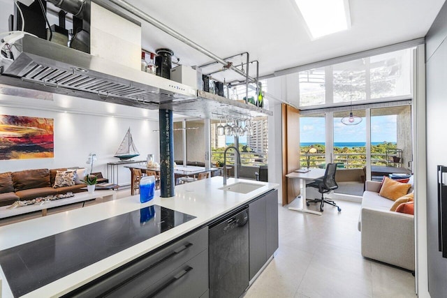 kitchen featuring cooktop, gray cabinetry, dishwasher, and sink