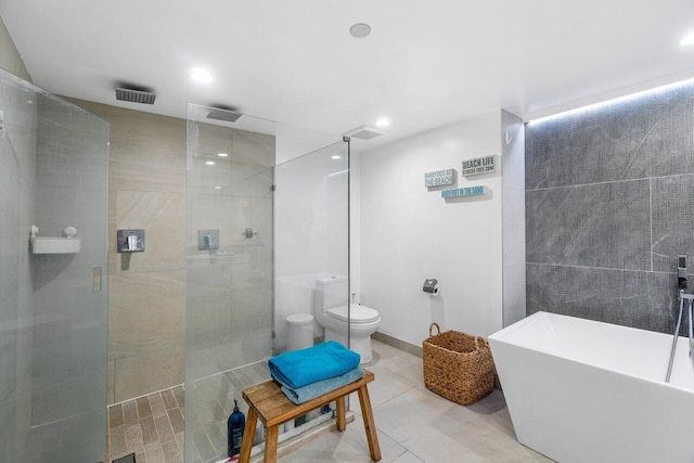 bathroom featuring tile patterned floors, toilet, and plus walk in shower