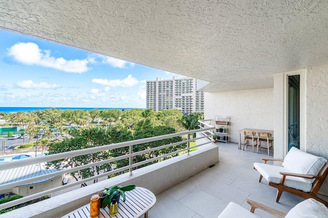 balcony with a water view and exterior bar