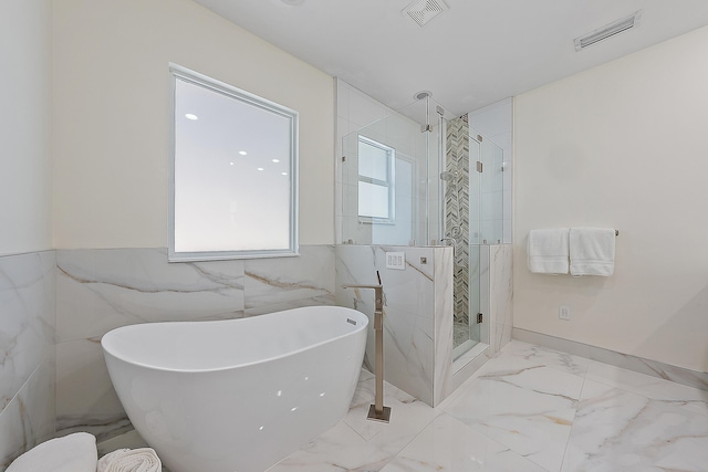 bathroom featuring separate shower and tub