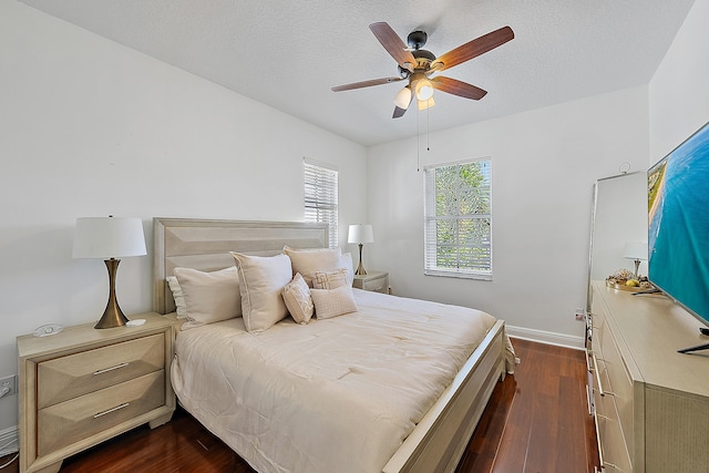 bedroom featuring a textured ceiling, dark hardwood / wood-style floors, and ceiling fan