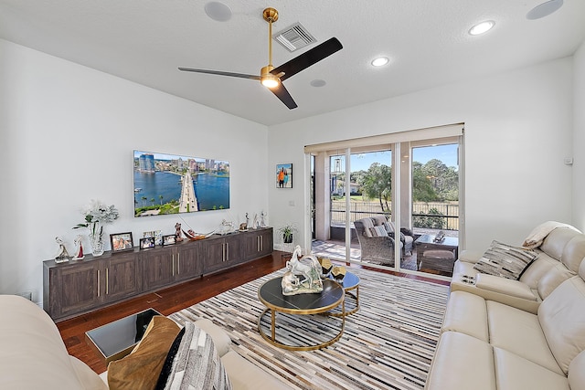 living room with vaulted ceiling, dark hardwood / wood-style floors, and ceiling fan