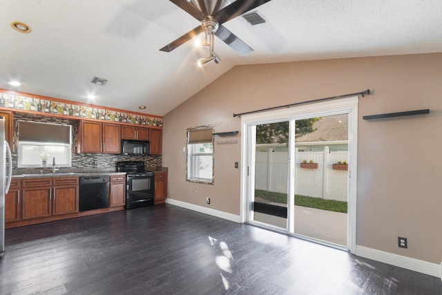 kitchen with ceiling fan, sink, dark hardwood / wood-style floors, vaulted ceiling, and black appliances