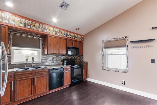 kitchen featuring black appliances, sink, vaulted ceiling, dark hardwood / wood-style floors, and a textured ceiling