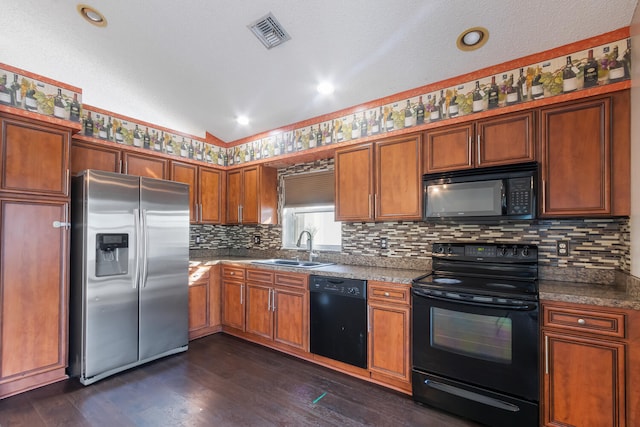 kitchen with sink, dark hardwood / wood-style floors, backsplash, lofted ceiling, and black appliances