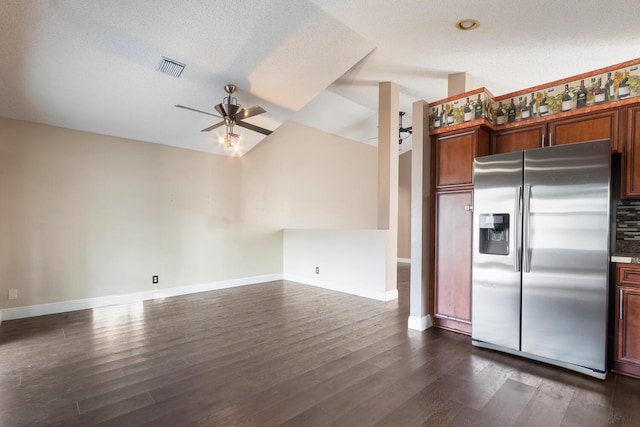 kitchen with dark hardwood / wood-style flooring, a textured ceiling, vaulted ceiling, ceiling fan, and stainless steel fridge with ice dispenser