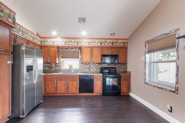 kitchen with sink, vaulted ceiling, dark wood-type flooring, and black appliances