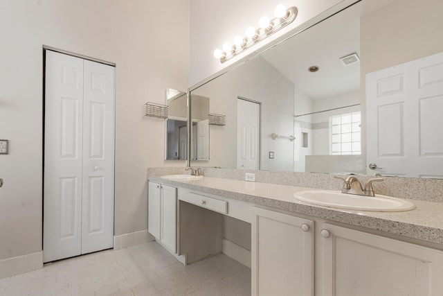 bathroom featuring vanity, vaulted ceiling, and walk in shower