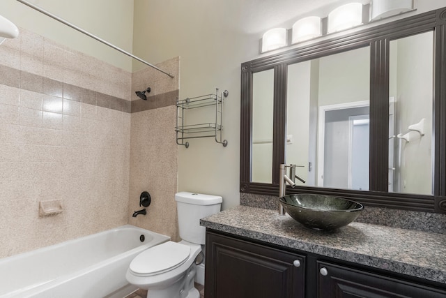 full bathroom featuring vanity, toilet, and tiled shower / bath