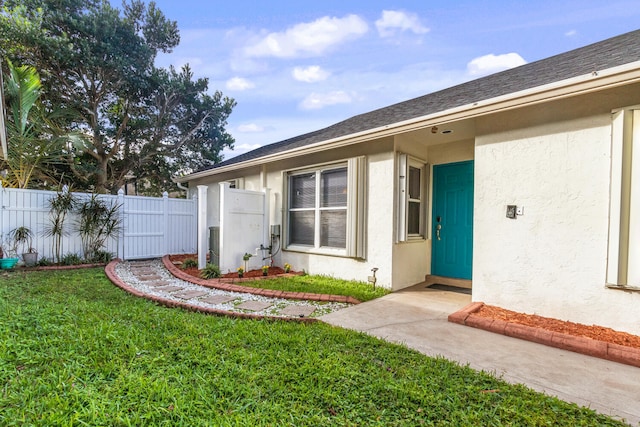 property entrance featuring a lawn