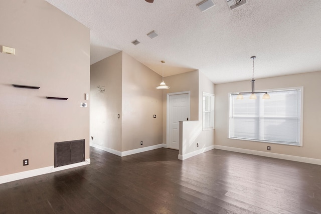 spare room with dark wood-type flooring and a textured ceiling